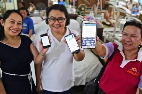Image of three women presenting LEARNS App on their mobile phones