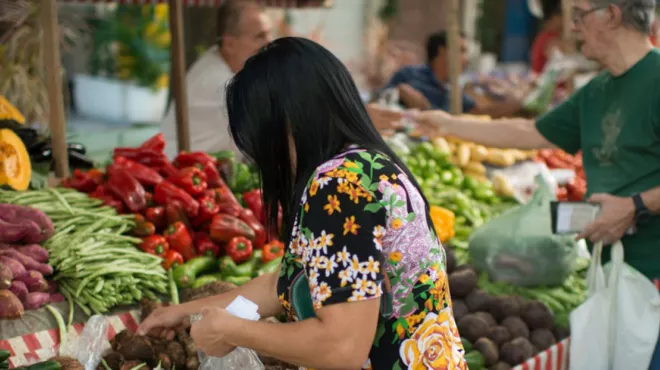Woman buying vegetables on a market in Brazil