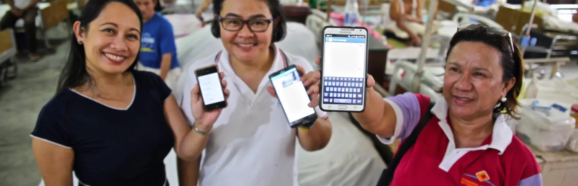 Image of three women presenting LEARNS App on their mobile phones