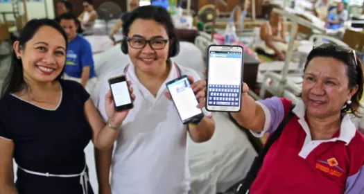 Image of three women presenting LEARNS on their mobile phones