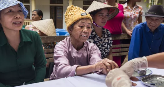 Patients getting screened in a community health camp in Vietnam