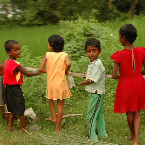 Four children carrying a branch