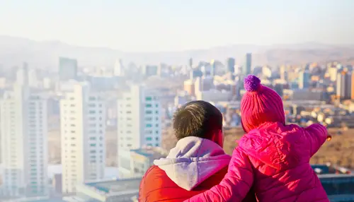 Dad and daughter looking at a city skyline