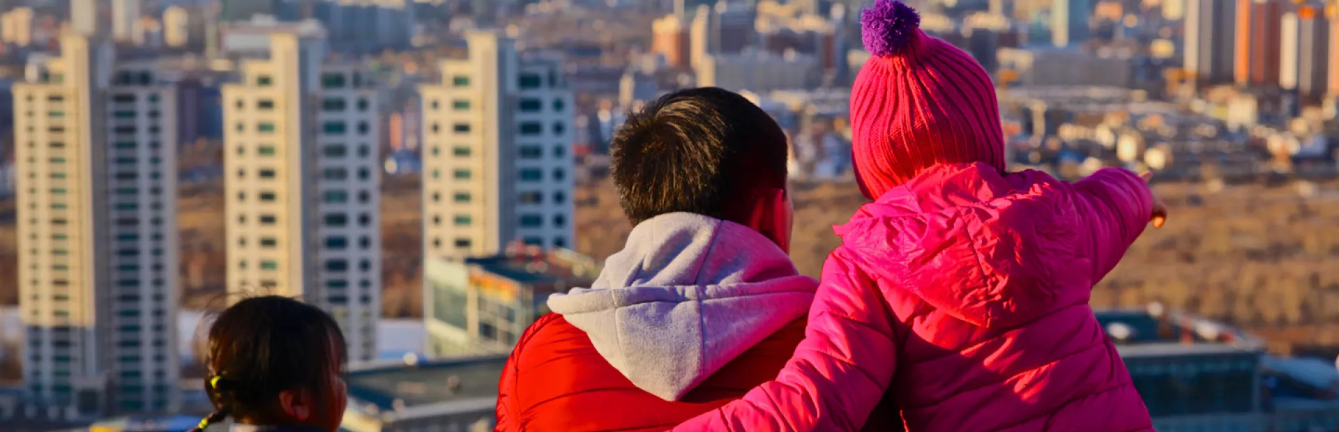 Man with children looking over the city of Ulaanbaatar