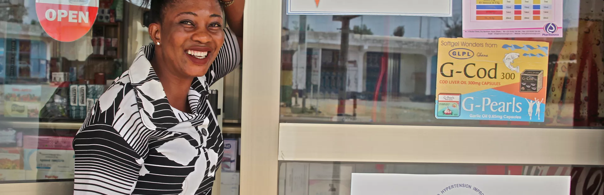 Image for community-based hypertension improvement with women in front of a pharmacy in Ghana