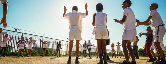 A group of children playing outside and learning about heart health in South Africa