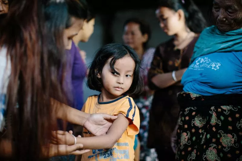 Little girl showing her arm, leprosy post exposure prophylaxis program