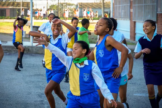 Children in the KaziBantu program, South Africa, doing physical education activities outside of the school