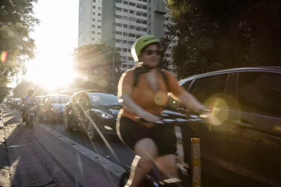Girl on bicycle, riding through São Paulo