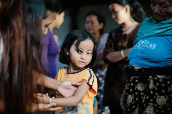 Little girl showing her arm, leprosy post exposure prophylaxis program