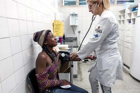 HCP checking patient's blood pressure in medical environment