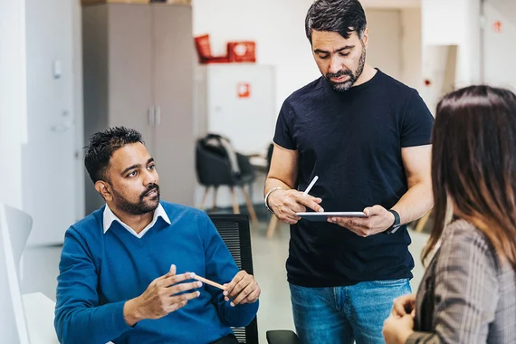 Three business people discussing in a meeting room