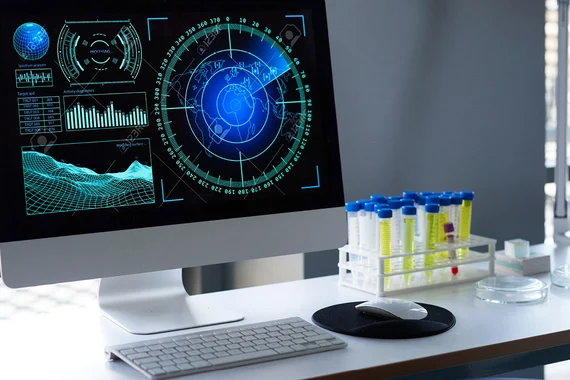 Powered on desktop computer laying next to medical material