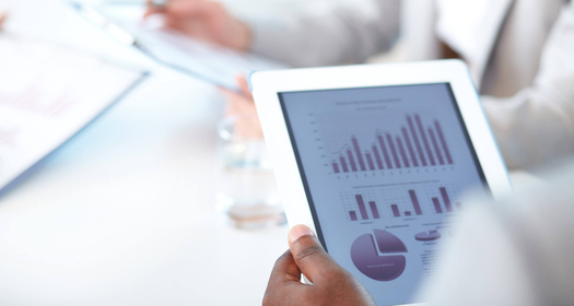 Close up picture of a white tablet displaying metrics