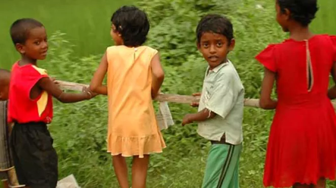 Four children carrying a branch