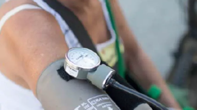 Middle aged woman with blood pressure monitor