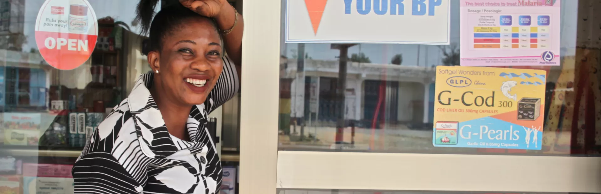 Image for community-based hypertension improvement with women in front of a pharmacy in Ghana